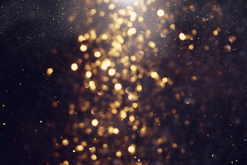 background of abstract glitter lights. gold and black. de focused
