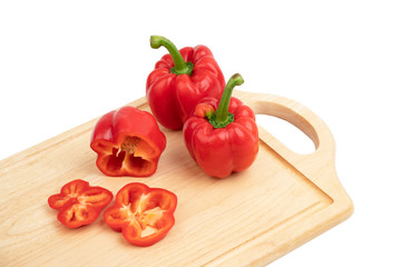 red sweet pepper or bell pepper on cutting board isolate on white background