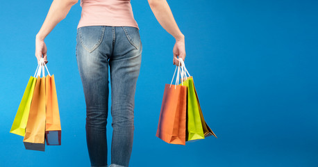 woman with colorful shopping bags  ,isolated on blue background