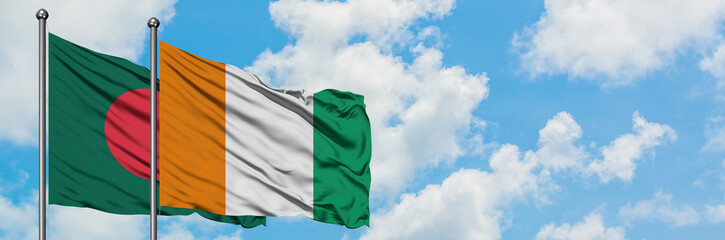 Bangladesh and Cote D'Ivoire flag waving in the wind against white cloudy blue sky together....