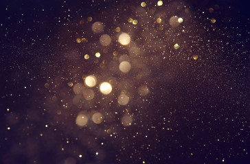 Fototapeta na wymiar background of abstract glitter lights. gold and black. de focused