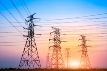 Fototapeta premium Electricity tower silhouette and sky landscape at dusk