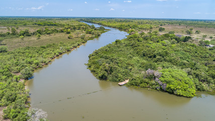 Areal view of typical Pantanal river meanderin through rainforest and deforested areas, Pantanal Wetlands, Mato Grosso, Brazil