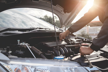 Technician working on checking and service car auto mechanic working in garage. Repair service.