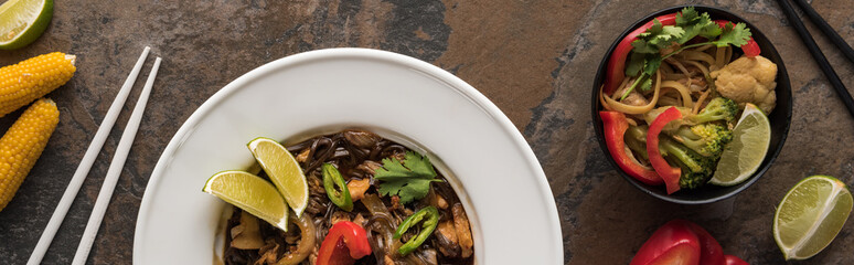 top view of thai noodles with vegetables and meat near chopsticks, panoramic shot, panoramic shot