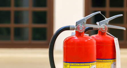 Red fire extinguishers available in fire emergencies,safety concept.