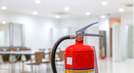Red fire extinguishers available in fire emergencies,safety concept.