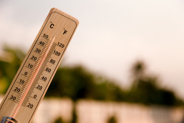 Thermometer displaying hot temperatures in sun summer day.