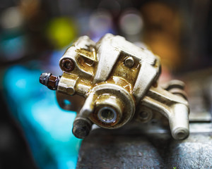 ATV hydraulic disc brake caliper system repair in old garage
