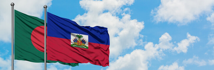 Naklejka na ściany i meble Bangladesh and Haiti flag waving in the wind against white cloudy blue sky together. Diplomacy concept, international relations.