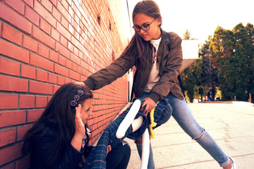 Schoolyard bullies, concept of this taking place after school,Aggressive teenagers bullying girl...