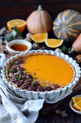 Pumpkin tart on a dark wooden background, still life
