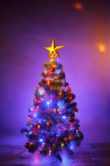 Christmas tree with festive lights, purple background
