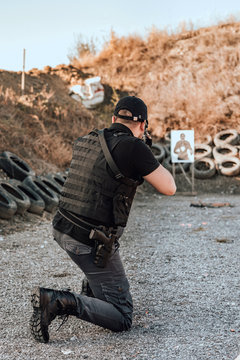 Man practice shooting gun, rifle outdoors.