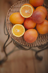 Red and yellow oranges on a wicker stand