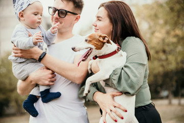 Family bonds. Happy young family of three smiling while spending free time outdoors