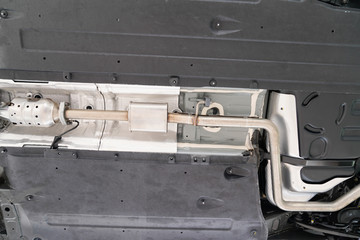 car undercarriage on hydraulic lift in garage station workshop during inspection chassis