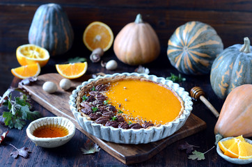 Pumpkin tart on a dark wooden background, still life