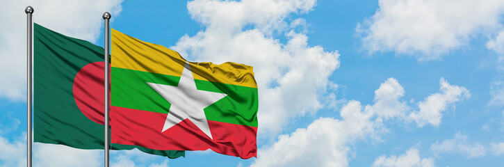 Bangladesh and Myanmar flag waving in the wind against white cloudy blue sky together. Diplomacy...