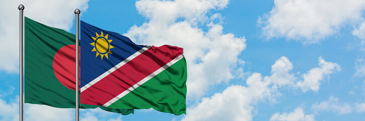 Bangladesh and Namibia flag waving in the wind against white cloudy blue sky together. Diplomacy concept, international relations.