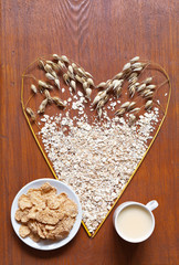 Wholesome oat products for heart and blood vessels: oat milk, breakfast cereal and raw oatmeal on a...