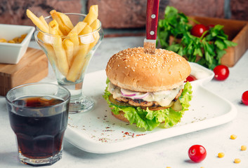 burger is served with fried potato and red wine
