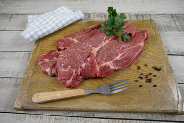 big raw steak on a cutting board