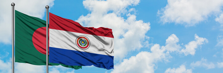 Bangladesh and Paraguay flag waving in the wind against white cloudy blue sky together. Diplomacy concept, international relations.