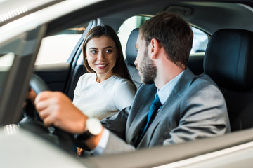 selective,focus,of bearded man driving car and looking at girl