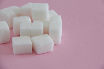 The word Drug spelled out with sugar cubes on pink background