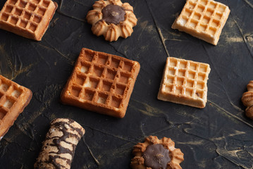 flat lay image of the wafer on the dark table, pattern cookies,