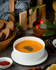 merchi soup in the bowl served with black bread and fresh tomato