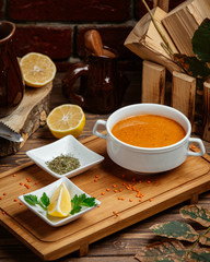 merchi soup served with piece of fresh lemon in the board dish