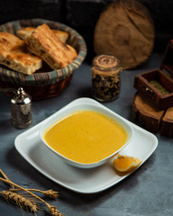 merci soup in the bowl served with piece of lemon