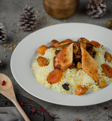 pilov is decorated with dried apricot and dried fruit in the dish