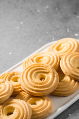 Cookies on a white ceramic tray on the gray kitchen table