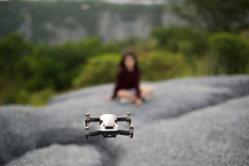 Flying drones taking pictures of girls in high angles