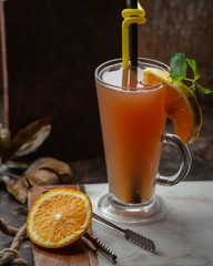 fresh fruit juice with piece of lemon in the glass