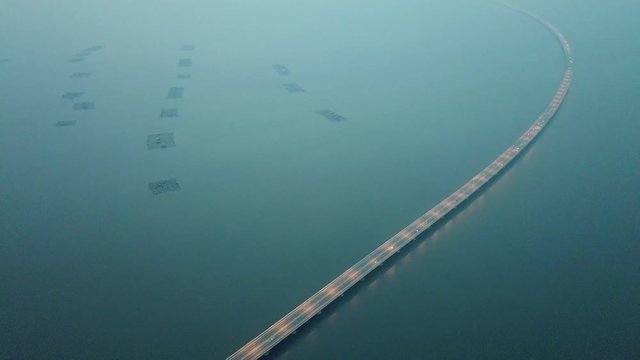 Aerial Sultan Abdul Halim Muadzam Shah Bridge with car traffic in dusk