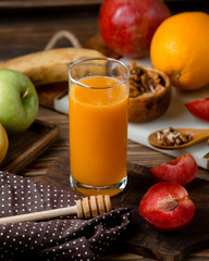 glass of fresh juice with assortment fruits