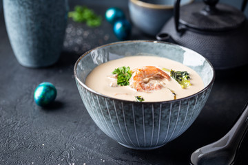 Tom Yum Kung soup, a Thai traditional spicy prawn soup in a bowl on dark background