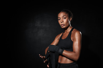 Fototapeta na wymiar Image of attractive african american woman wearing boxing hand wraps