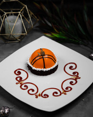 small sweet oval cake decorated with chocolate