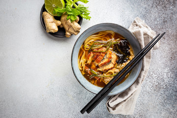 japanese soup with fried eel Yanagawa Nabe in a bowl on gray background, top view