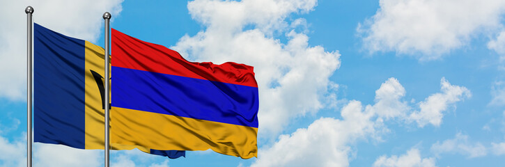 Barbados and Armenia flag waving in the wind against white cloudy blue sky together. Diplomacy concept, international relations.