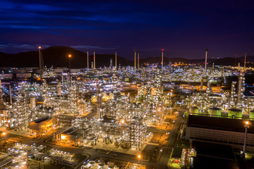 Fototapeta premium twilight landscape refinery oil and gas at night aerial view