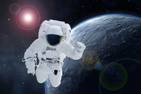 Astronaut over a potentially habitable planet. Elements of this image were furnished by NASA.