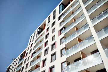 Modern apartment buildings on a sunny day with a blue sky. Facade of a modern apartment building