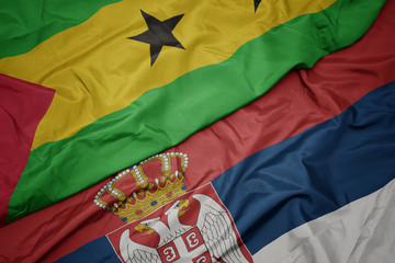 waving colorful flag of serbia and national flag of sao tome and principe .