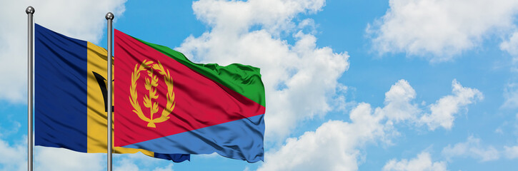 Fototapeta premium Barbados and Eritrea flag waving in the wind against white cloudy blue sky together. Diplomacy concept, international relations.